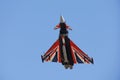 A close-up shot of the RAF Typhoon, callsign Blackjack as it flies against a bright blue sky Royalty Free Stock Photo