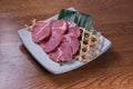 Close-up shot of raw marble meat slices on a plate Royalty Free Stock Photo
