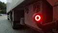 Close-up shot of the rear round red marker light of a truck. Rear light for a truck. The background is blurred. The concept of Royalty Free Stock Photo