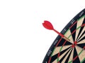 Close up shot red dart arrow on center of dartboard, metaphor to target success, winner concept, Isolated on white background with