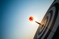 Close up shot red darts arrows in the target center on dark blue sky background. Business target or goal success and winner Royalty Free Stock Photo