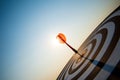 Close up shot red darts arrows in the target center on dark blue sky background. Business target or goal success and winner Royalty Free Stock Photo