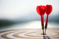 Close up shot red darts arrows in the target center on dark blue sky background. Business target or goal success and winner Royalty Free Stock Photo