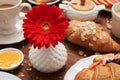 Close-up shot of red flower in vase among healthy breakfast Royalty Free Stock Photo