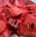 A close-up shot of red juicy cut pieces of water melon with seeds