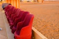 Close up shot of red muddha cane chairs sofas with small yellow brick walls for seating visitors during a performance Royalty Free Stock Photo