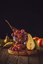 close-up shot of ripe grapes with pears on rustic wooden table Royalty Free Stock Photo