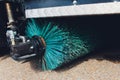 Close up shot of a road brush sweeping machine.