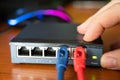 Close-up shot of a router - a red cable is connected next to the blue Ethernet cable. Concept of cabling, internet network,