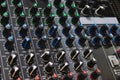 Close-up shot of rows of control knobs and buttons on a digital multi effect processor unit