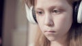 A close-up shot of a rushing plan portrait of a serious pensive and detached girl who is 10 years old in large white