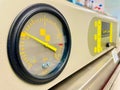 Close-up shot of a scientific pressure gauge instrument with a yellow indicator in the laboratory