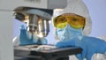 Close-up shot of a scientist preparing glass slide with dangerous bacteria for examining under microscope Royalty Free Stock Photo