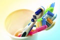 Close up shot of set of multicolored toothbrushes in glass on cl Royalty Free Stock Photo