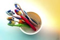 Close up shot of set of multicolored toothbrushes in glass on cl Royalty Free Stock Photo