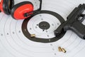 Close up shot of a shooting target and bullseye with bullet holes with automatic pistol gun and cartridge bullet. Royalty Free Stock Photo