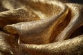 Close up of textured and folded shimmering golden fabric material Royalty Free Stock Photo