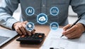 A close-up shot shows people working at a desk, with a digital overlay of interconnected icons representing AI, cloud computing, Royalty Free Stock Photo