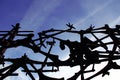 Close-up shot of a silhouette of a metal structure with a cloudy blue sky in the background