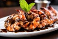 close-up shot of a single grilled shrimp with sauce glaze