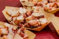 Close-up shot of sliced octopus with olive oil and parsley.