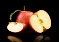 Close-up shot sliced red apple with leaf isolated Royalty Free Stock Photo