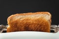 Close-up shot of slightly burnt white bread toasts sticking out of a toaster on the black background. Ready toasts with a dark Royalty Free Stock Photo