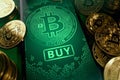 Close-up shot on a smartphone screen with Bitcoin image and big BUY button on the display. Bitcoin buy opportunities concept. 3D