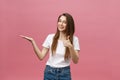 Close-up shot of smiling pretty girl showing thumb up gesture. Female isolated over pink background in the studio. Royalty Free Stock Photo