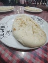 Close-up shot of soft and fluffy naan bread on white plate Royalty Free Stock Photo