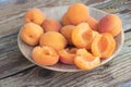 Close up of shot some sweet and fresh apricots on wooden plate