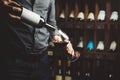 Close up shot of sommelier pouring red wine from bottle in glass on underground cellar background Royalty Free Stock Photo