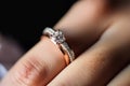 Close-up of a sparkling diamond engagement ring on a finger, symbolizing love Royalty Free Stock Photo