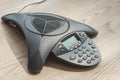 close-up shot of speakerphone on wooden table