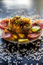 Close up shot of spicy tasty sabudana khichdi or sago ball khichdi along with some sliced tomatoes, some cut lemons in a glass pla