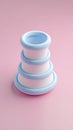 Stacked blue and white objects on a pink background Royalty Free Stock Photo