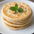 Stack of golden brown savory flatbreads topped with fresh mint Royalty Free Stock Photo