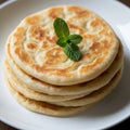 Stack of golden brown flaky flatbread topped with fresh mint Royalty Free Stock Photo