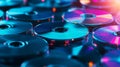 A closeup shot of a stack of shiny CDs on a blue background The CDs are arranged in a random pattern creating a visual interest Royalty Free Stock Photo