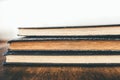 Close-up shot of stack of vintage books on wooden table