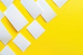A close-up shot of a stack of white papers placed on a bright yellow surface Royalty Free Stock Photo