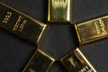 Close up shot of stacked 999.9 pure gold bar ingot on a black background