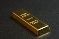 Close up shot of stacked 999.9 pure gold bar ingot on a black background