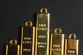 Close up shot of stacked 999.9 pure gold bar ingot on a black background