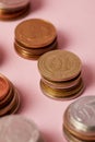 close-up shot of stacks of different coins on pink