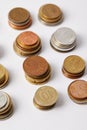 close-up shot of stacks of different coins on white