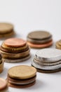 close-up shot of stacks of various coins on white