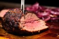 close-up shot of steel-serving fork piercing a slice of beef brisket