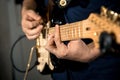 Close up shot of strings and guitarist hands playing guitar over black - shallow DOF with focus on hands Royalty Free Stock Photo