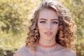 Close up shot of stylish young woman smiling. Beautiful woman with curly hair. Royalty Free Stock Photo